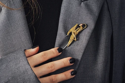 Vintage brooch with rollover clasp pinned to a navy blazer