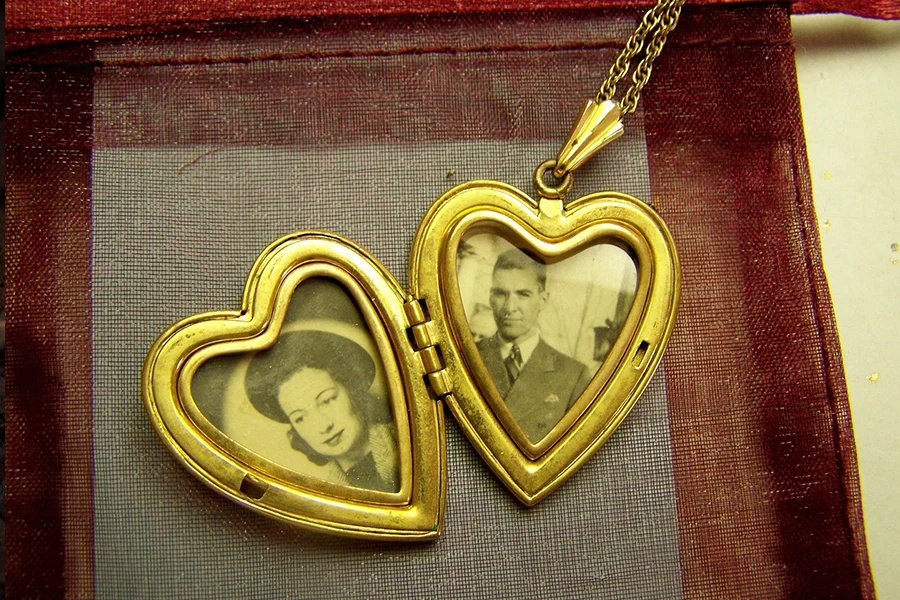 Vintage gold locket open with two small photos inside