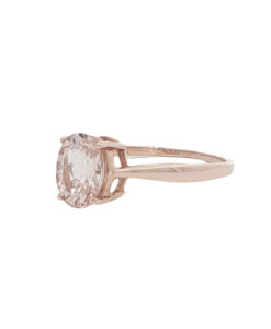 Side view of 10ct rose gold morganite solitaire ring with four-claw setting.