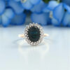 9ct Gold Sapphire and Diamond Cluster Ring with flowers in the back ground