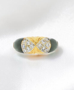 Kutchinsky ring sitting on white silk