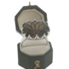 Sterling silver smoky quartz statement ring with large faceted oval gemstone and decorative openwork claw setting.