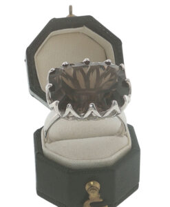 Sterling silver smoky quartz statement ring with large faceted oval gemstone and decorative openwork claw setting.
