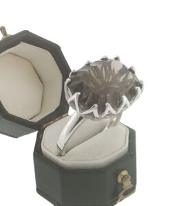 Sterling silver smoky quartz statement ring with large faceted oval gemstone and decorative openwork claw setting.